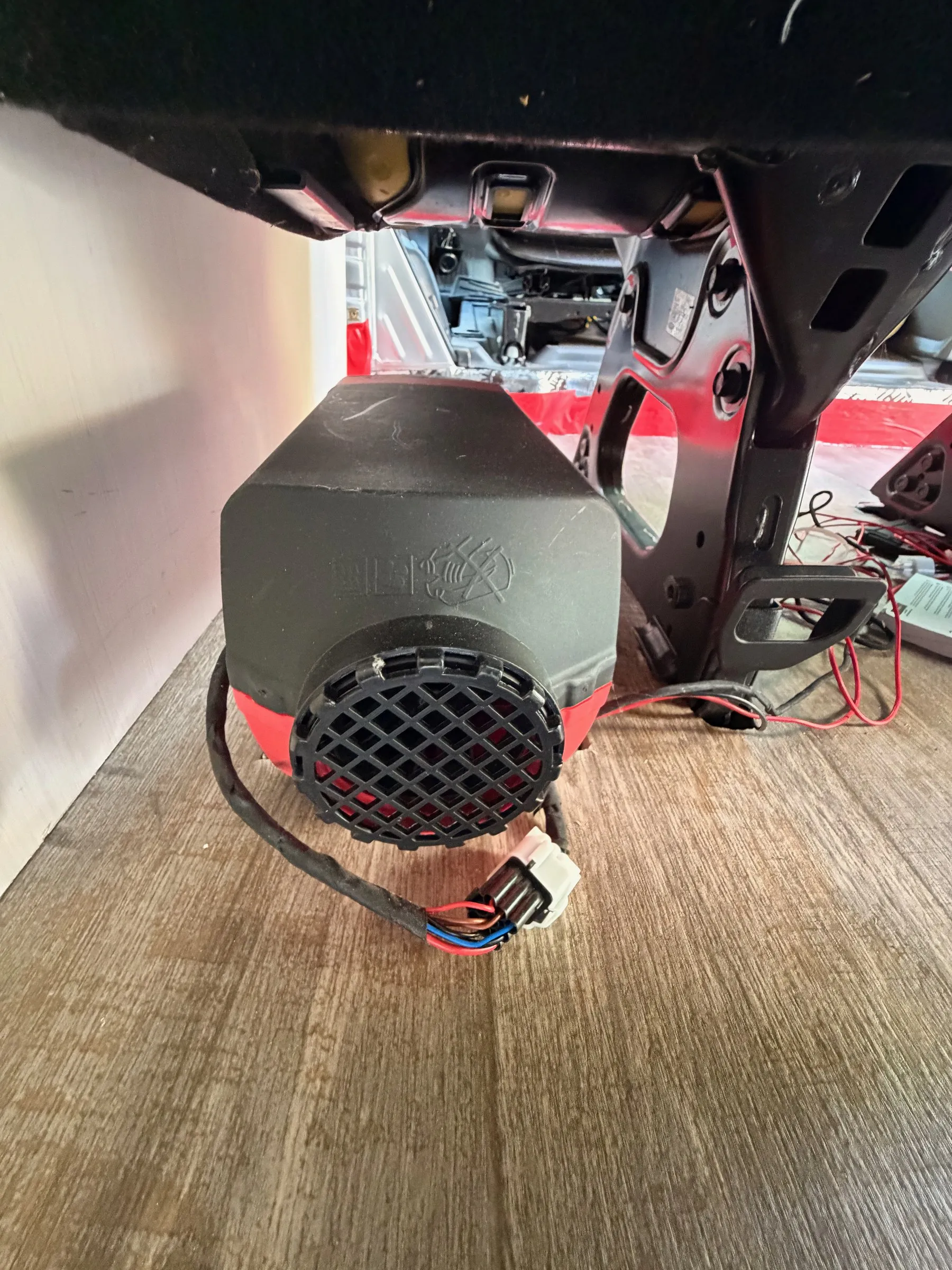 Compact diesel air heater mounted under the second-row seat frame