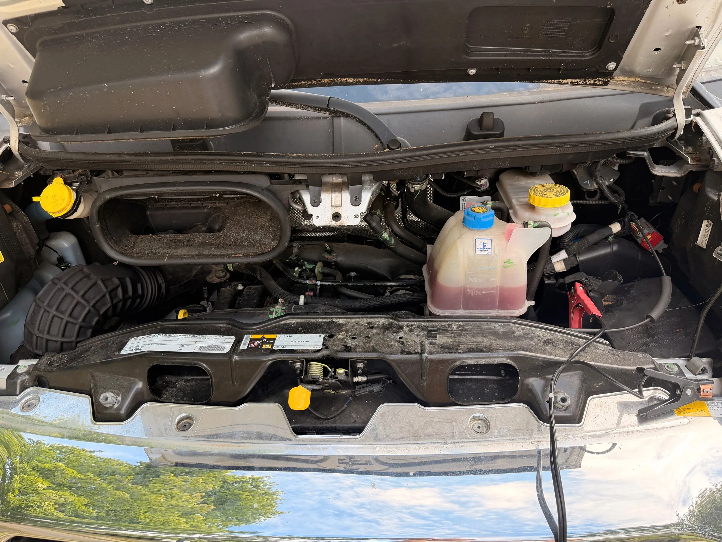 Open engine bay of the Ram ProMaster with coolant and fluid reservoirs
